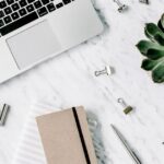 白いデスクの上のパソコンと観葉植物